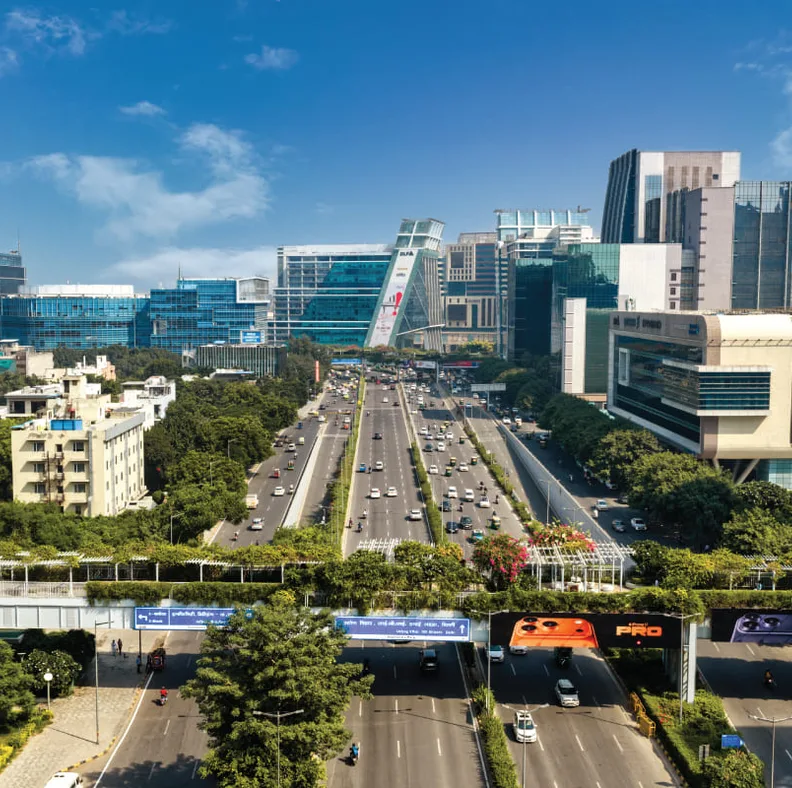 Aerial view of the New Delhi business district with glass office towers and a busy highway