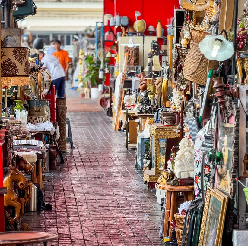 Aisle of a busy antiques and handicrafts market